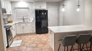 kitchen with bar stools and white painted kitchen cabinets