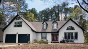white home with black garage doors and exterior painting