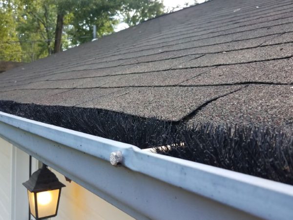 up close view of gutter and black roof