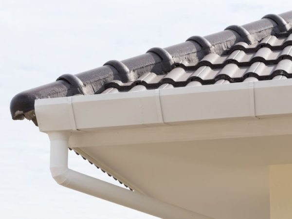 up close view of white gutter and black roof